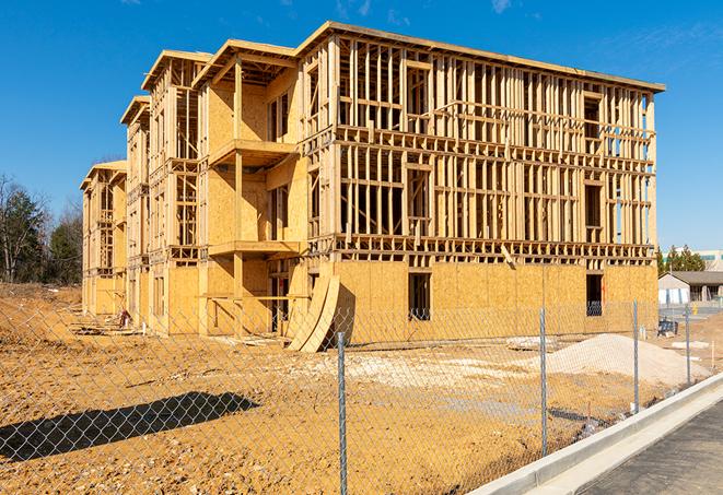 a close-up of temporary chain link fences enclosing a construction site, signaling progress in the project's development in Castle Creek